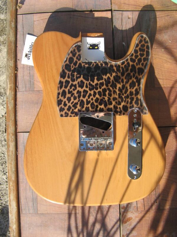 leopard pickguard on a natural guitar