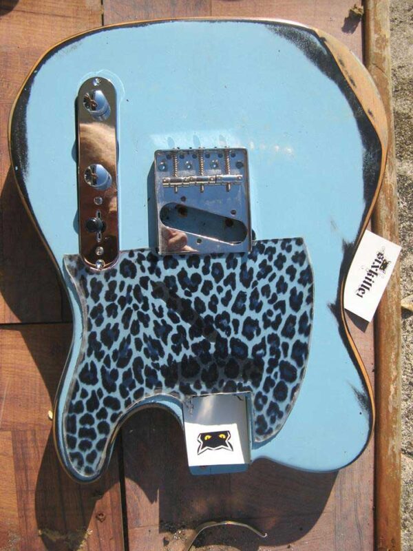 leopard pickguard on a blue guitar