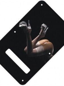 Betty is bent over wearing thong panties, white thigh-high stockings and platform heels on a black backplate