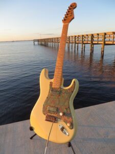 Fender Stratocaster with paisley pickguard displayed on the dock by the water