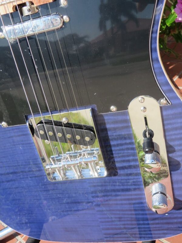 close-up of front blue flame maple topped tele