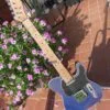 complete guitar front of blue flame maple topped tele