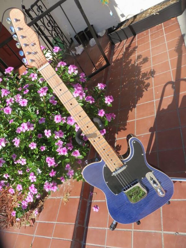 complete guitar front of blue flame maple topped tele